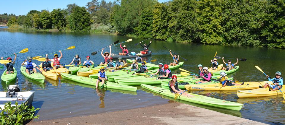 people in kayaks smiling for the camera