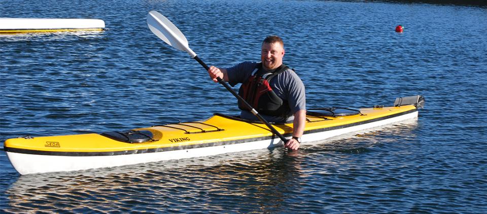 smiling man kayaking