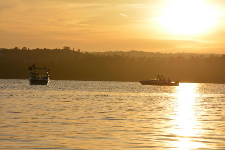 boats at sunset at folsom lake