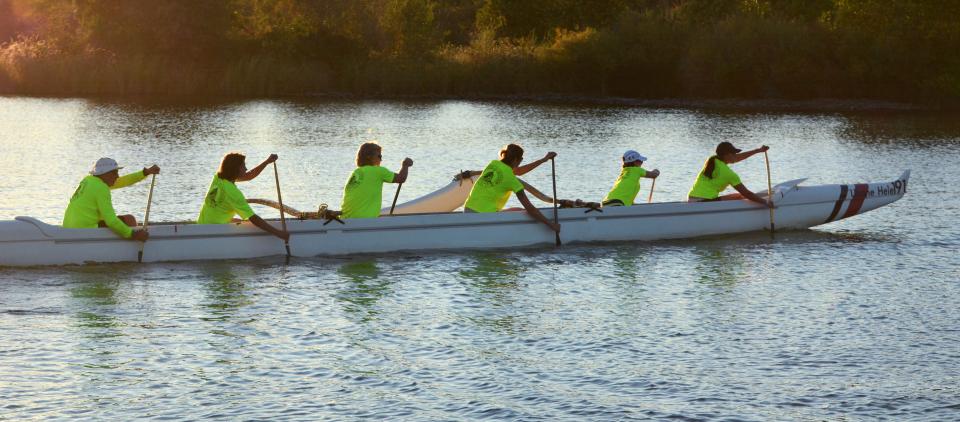 people in an outrigger canoe