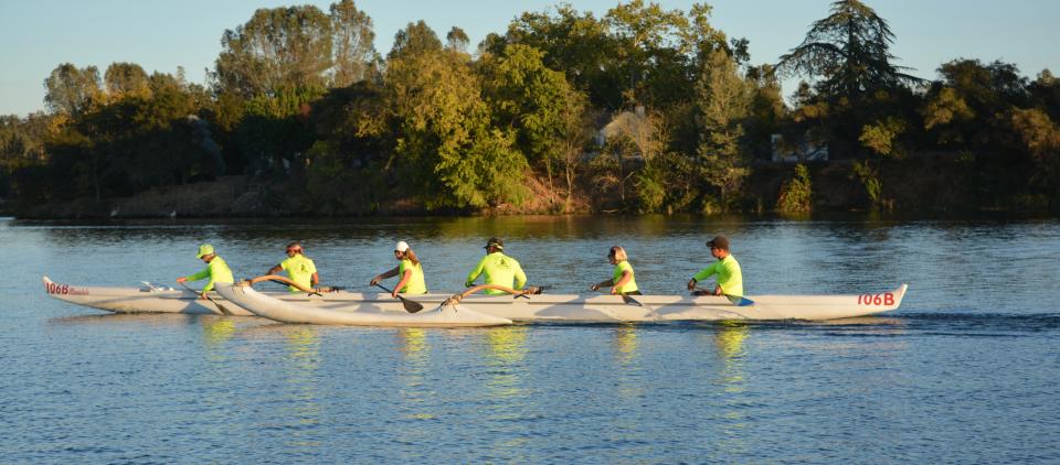 people rowing an outrigger canoe