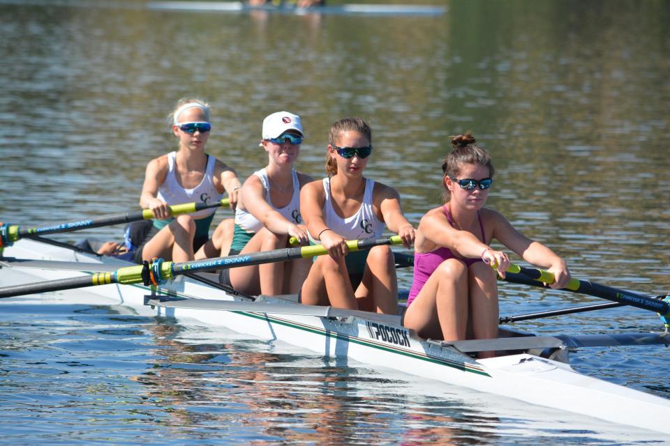 Four high school women athlete rowing on Lake Natoma