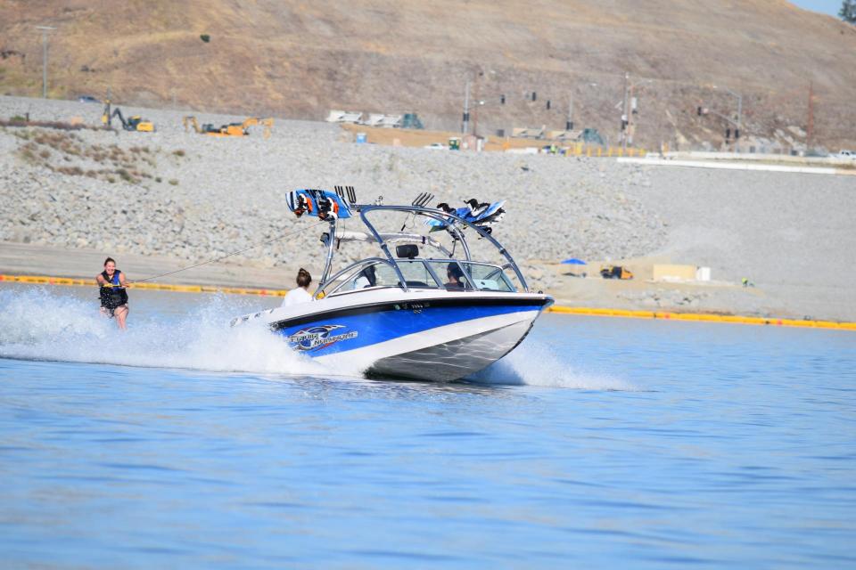 wakeboard boat on folsom lake pulling wakeboarder