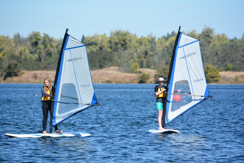 Two sac state students windsurfing on Lake Natoma