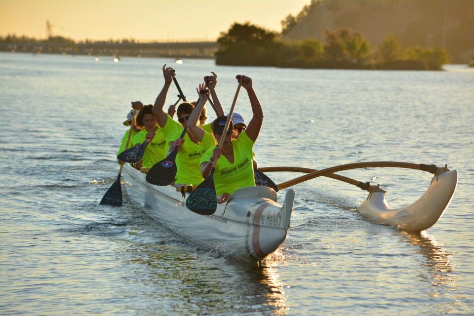 People outrigger canoeing