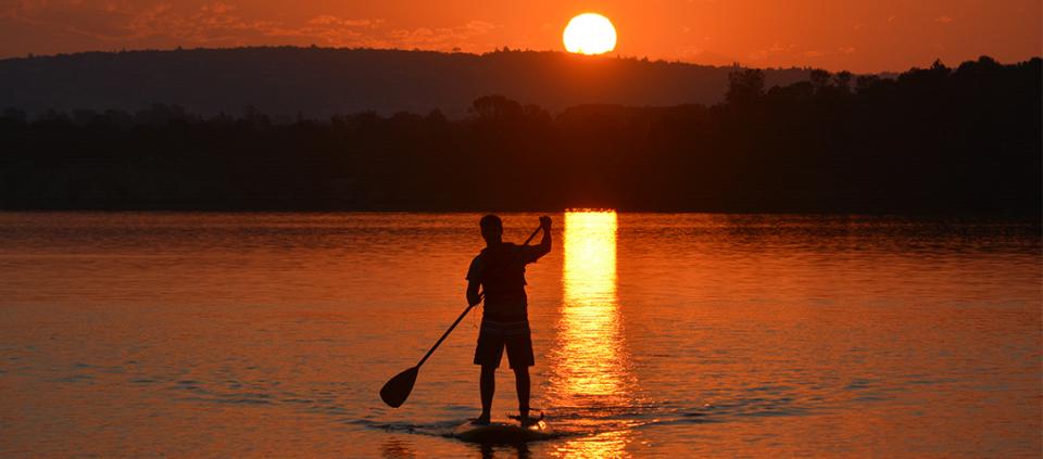 sunset stand up paddler