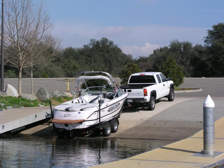 truck launching ski boat on boat ramp