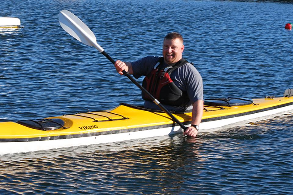 smiling man kayaking