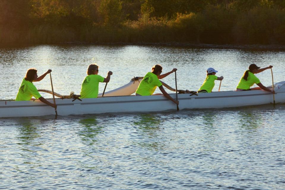 people in an outrigger canoe