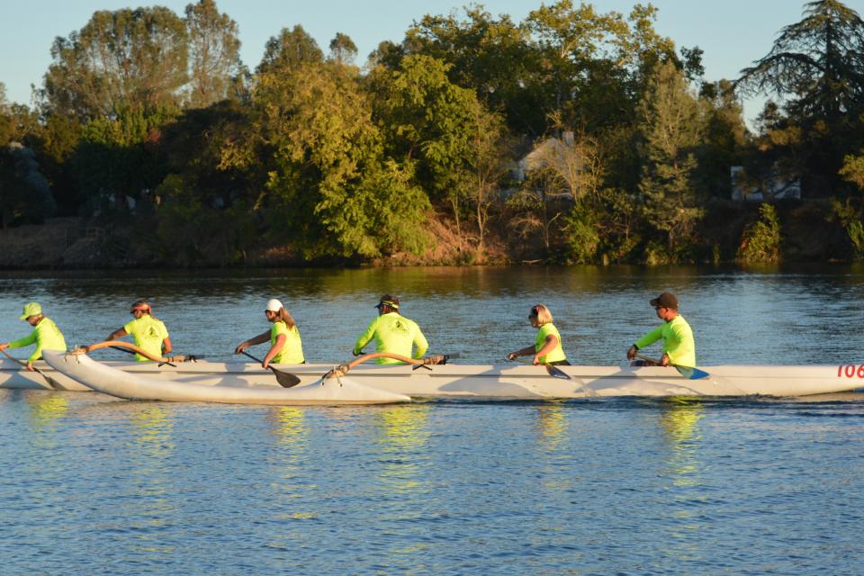people rowing an outrigger canoe