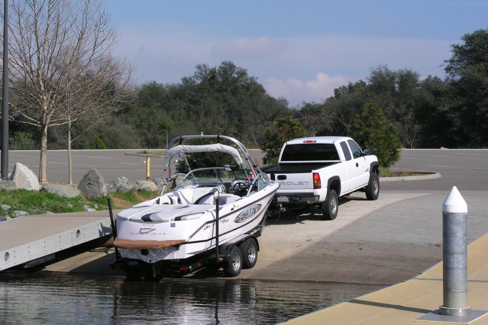 truck launching ski boat on boat ramp