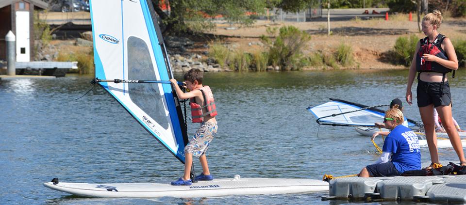 a young boy windsurfing