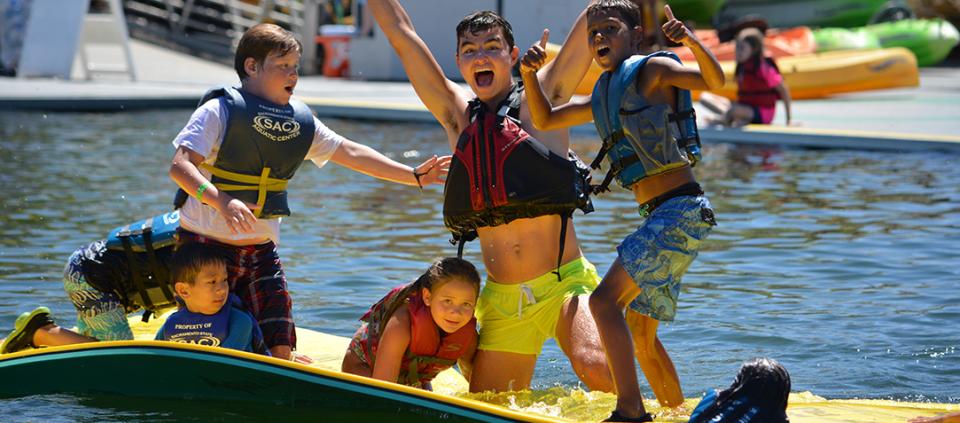 kids in a canoe smiling