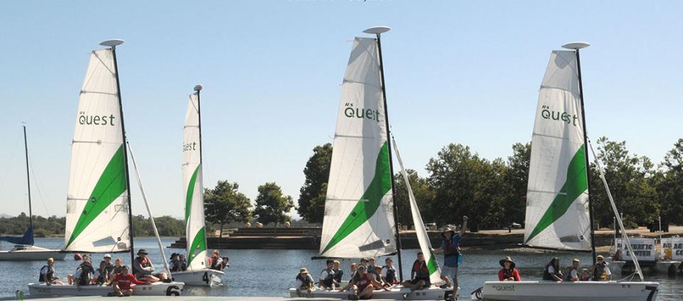 four sailboats on the water